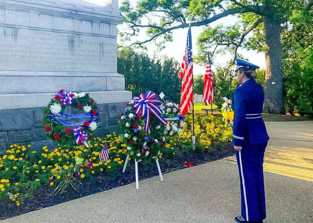 Gloria Williams salutes in uniform at memorial service